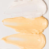 Three smears of skincare creams showing the texture of each.