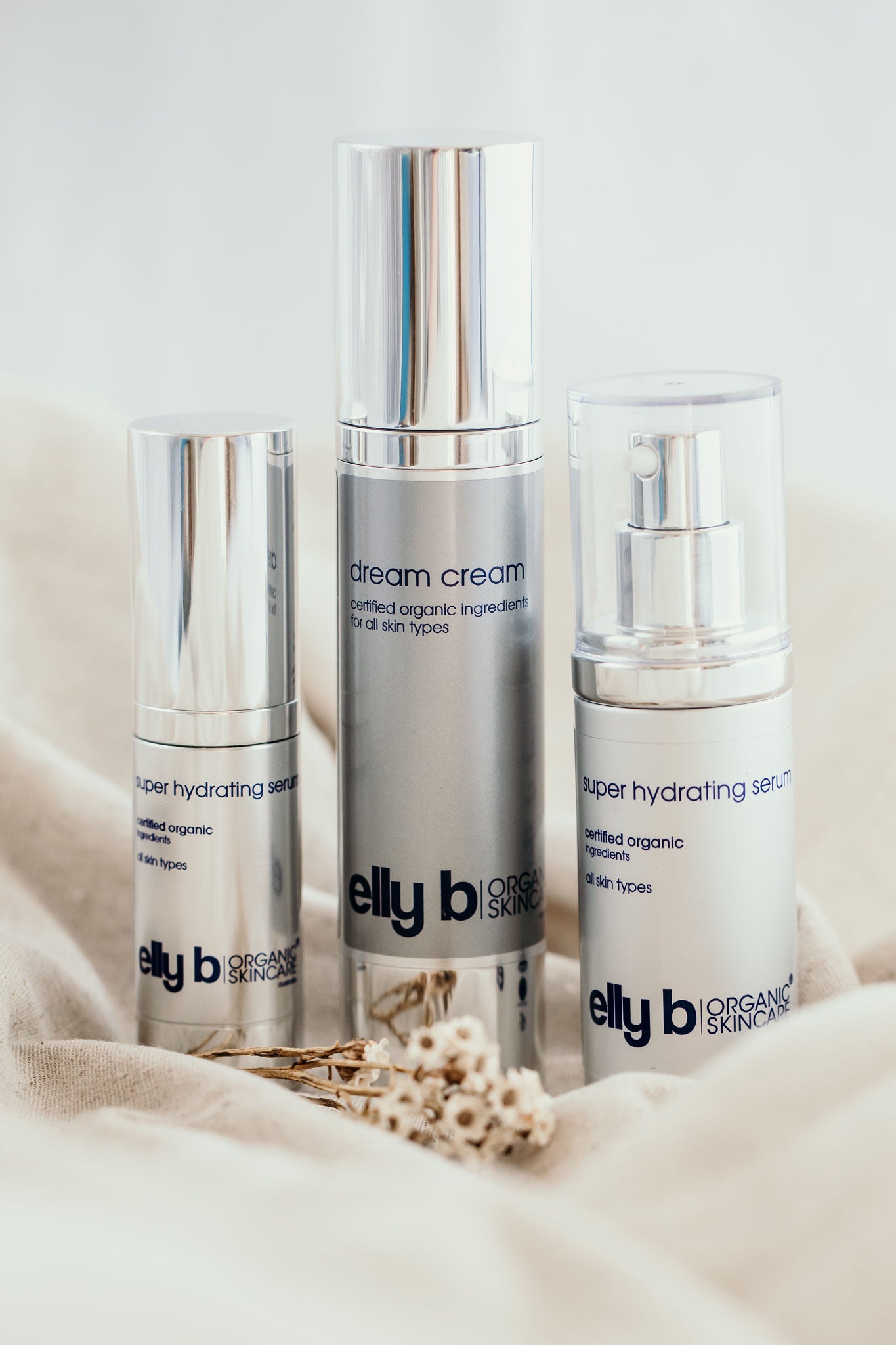 Three silver bottles on a beige cloth, making up the super hydration special.